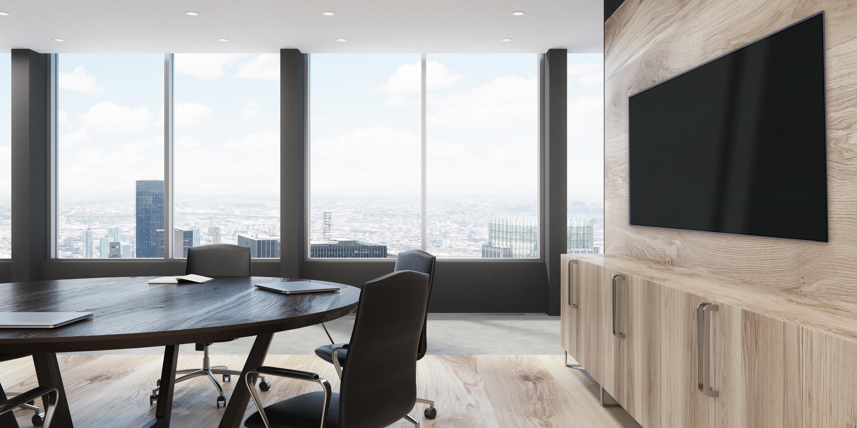 Conference room with a flat panel display and view overlooking the city.